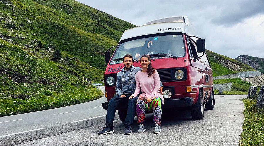 a couple infront of their VW bus