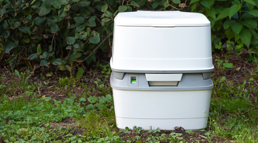 a chemical toilet on a meadow